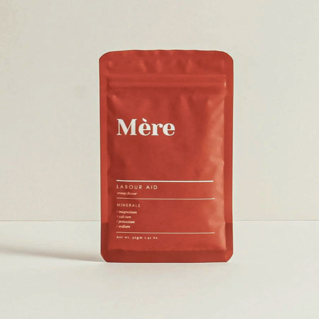 Mere botanicals labour aid packet standing upright against neutral background, orange pouch with white writing